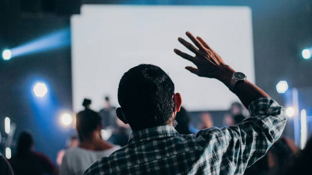 A man raises his hand at a press release event