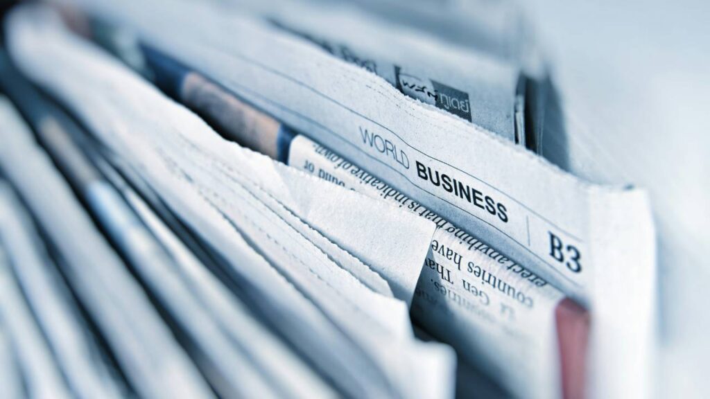 A stack of various business newspapers