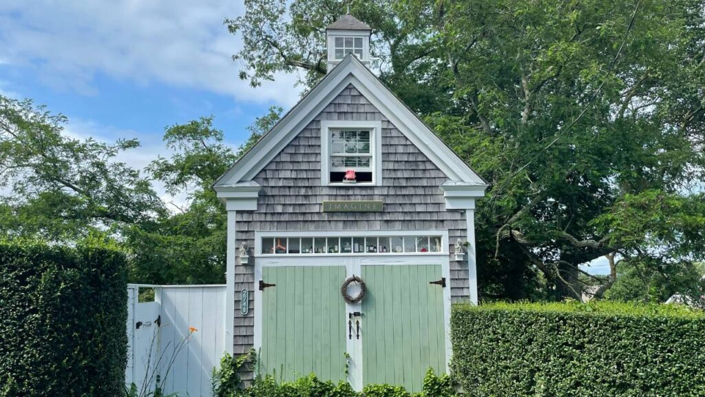 A photo of a small house situated in the garden