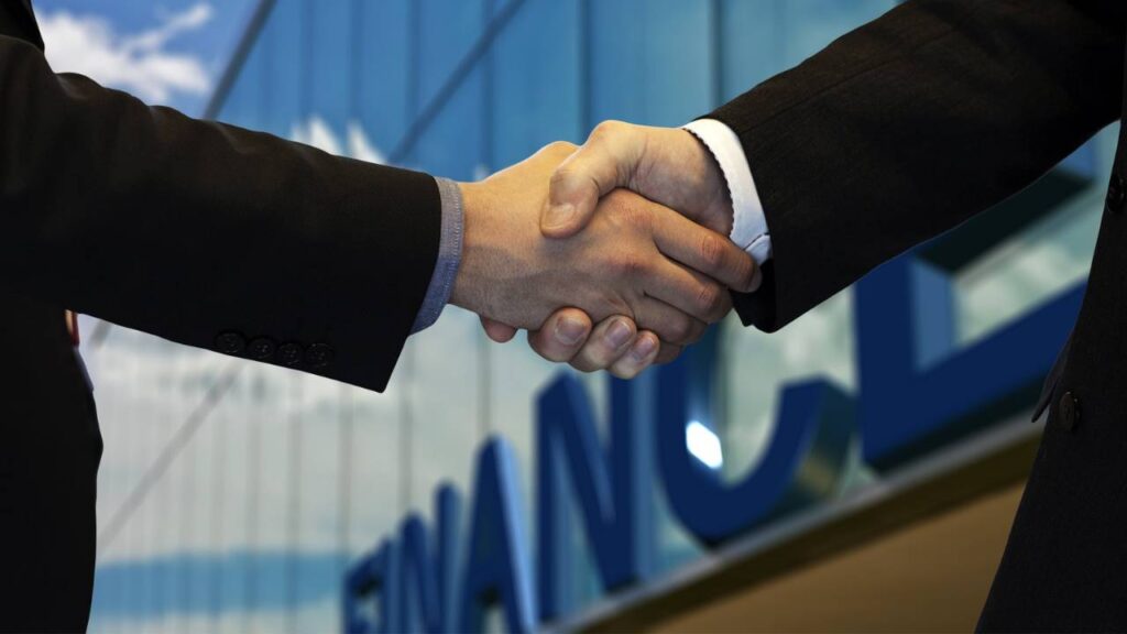 A client shaking hands with their financial advisor 