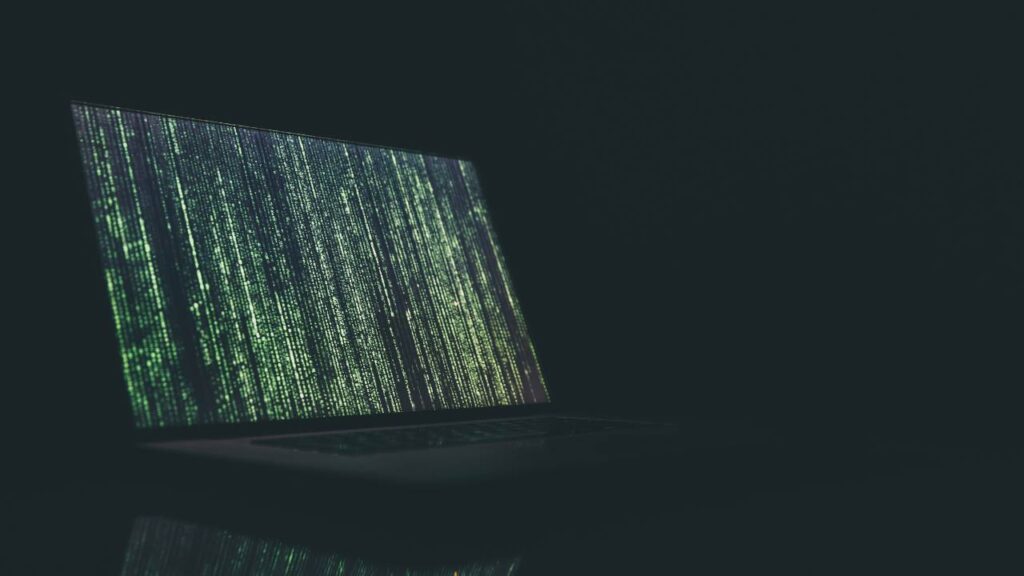 A photo of a laptop in a dark room 