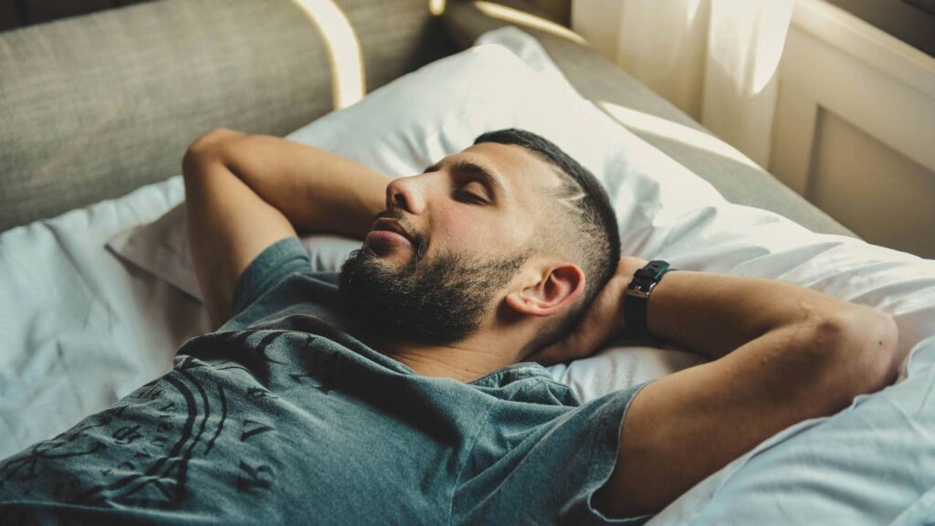 A photo of a guest laying on hotel bed